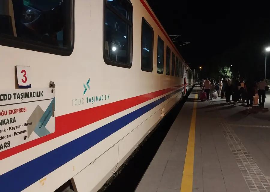 Eastern Express at a station after dark